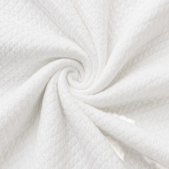 Carriage Boutique white quilted fabric texture for a baby bris outfit with a soft diamond pattern