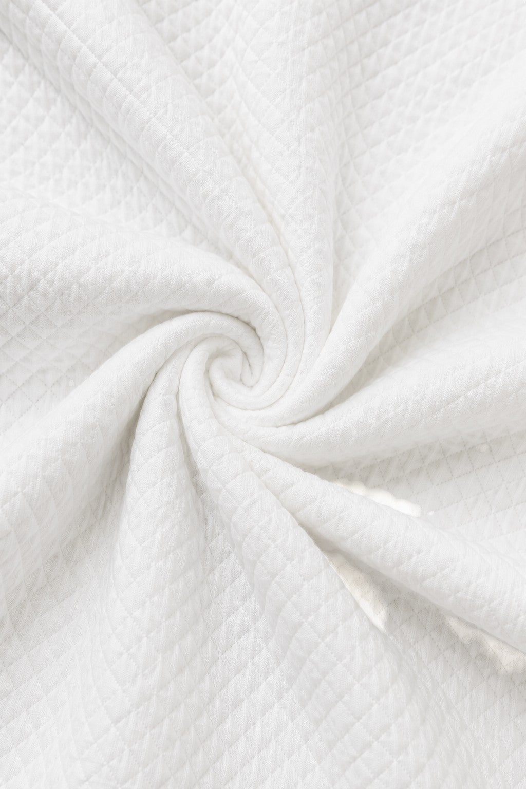 Carriage Boutique white quilted fabric texture for a baby bris outfit with a soft diamond pattern
