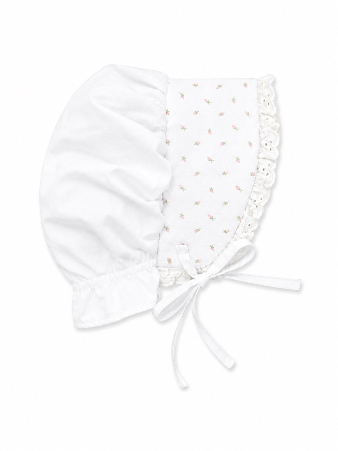 Carriage Boutique white baby bonnet featuring a delicate pink rosebud print, lace trim, and soft fabric ties.