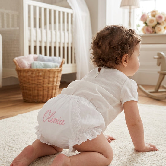Carriage Boutique baby girl cotton diaper cover in white with floral ruffles and personalized pink embroidery