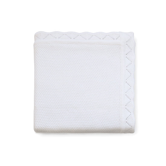 Carriage Boutique white cotton baby blanket with a delicate textured knit, diamond pattern, and scalloped edge.