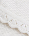 Carriage Boutique white cotton knit baby blanket featuring a delicate scalloped edge and textured diamond pattern.