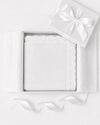 Carriage Boutique white cotton knit baby blanket with scalloped edges, presented in a gift box with a satin ribbon.