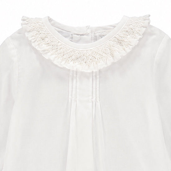 Carriage Boutique white baby girl long sleeve blouse featuring a delicate ruffled smocked collar and pleated front