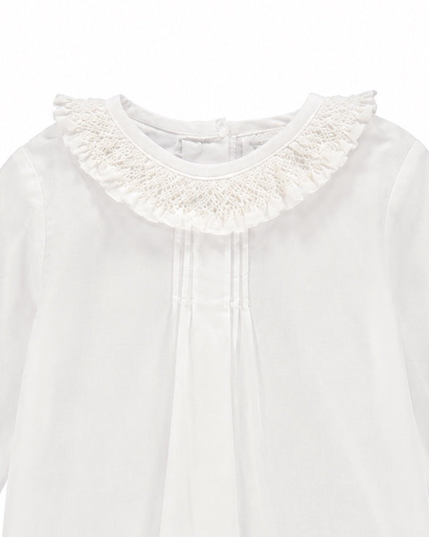 Carriage Boutique white baby girl long sleeve blouse featuring a delicate ruffled smocked collar and pleated front