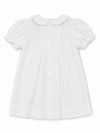 Carriage Boutique white heirloom baby dress featuring a Peter Pan collar, puffed sleeves, and back button closure.