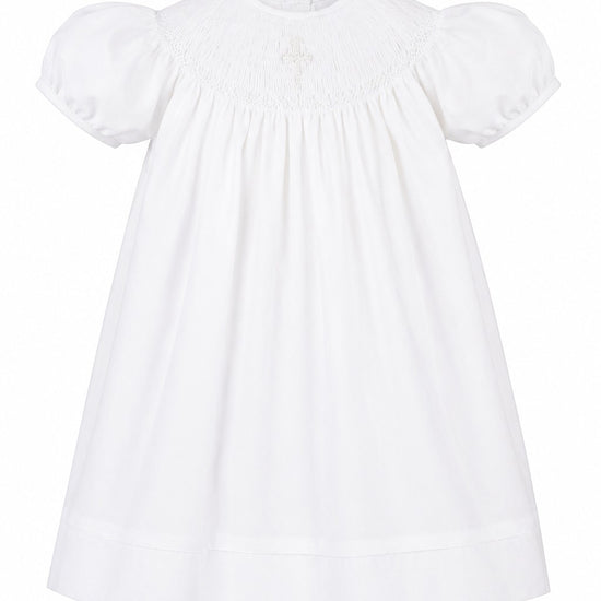 Carriage Boutique white cotton bishop dress with hand smocking and pearl cross detail for baby girls.
