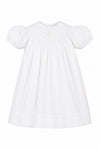 Carriage Boutique white cotton bishop dress with hand smocking and pearl cross detail for baby girls.
