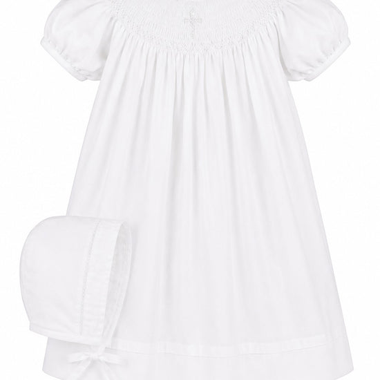Carriage Boutique white cotton baby bishop dress with hand smocked pearl cross detail and matching bonnet