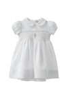 Carriage Boutique white smocked christening dress with cross detail and matching bonnet. Puff sleeves and Peter Pan collar.
