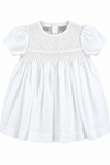 Carriage Boutique white baby girl christening voile dress with delicate smocked bodice and puff sleeves