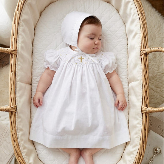 Carriage Boutique baby girl christening bishop dress in white cotton with gold smocked cross and matching bonnet