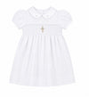 Carriage Boutique white baby girl christening dress with smocked bodice, cross embroidery, and peter pan collar.