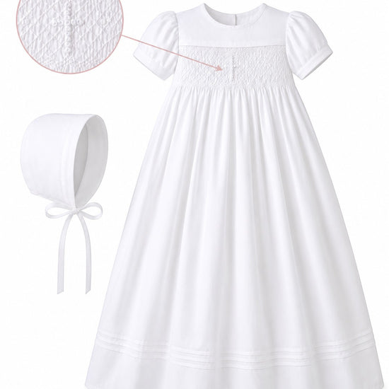 Carriage Boutique white infant christening gown with hand-smocked cross bodice detail and matching bonnet.