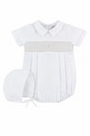 Carriage Boutique white baby boy christening bubble romper with smocked bodice, cross embroidery, and matching bonnet.