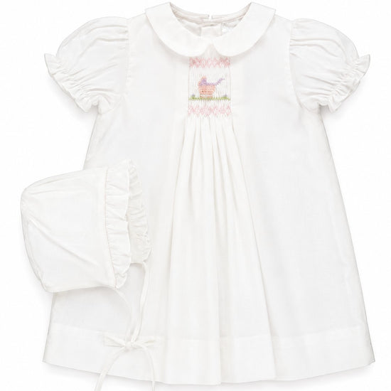 Carriage Boutique white smocked heirloom dress with pram embroidery and matching ruffled bonnet for baby girls.