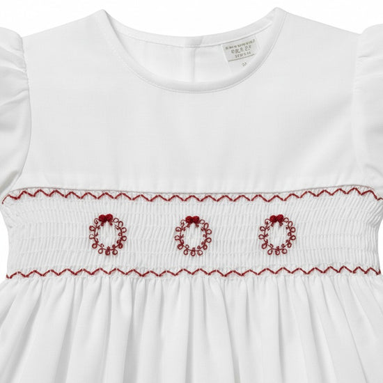 Carriage Boutique white toddler dress with red hand-smocked wreath embroidery and ruffled sleeves