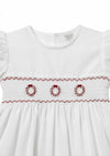 Carriage Boutique white toddler dress with red hand-smocked wreath embroidery and ruffled sleeves