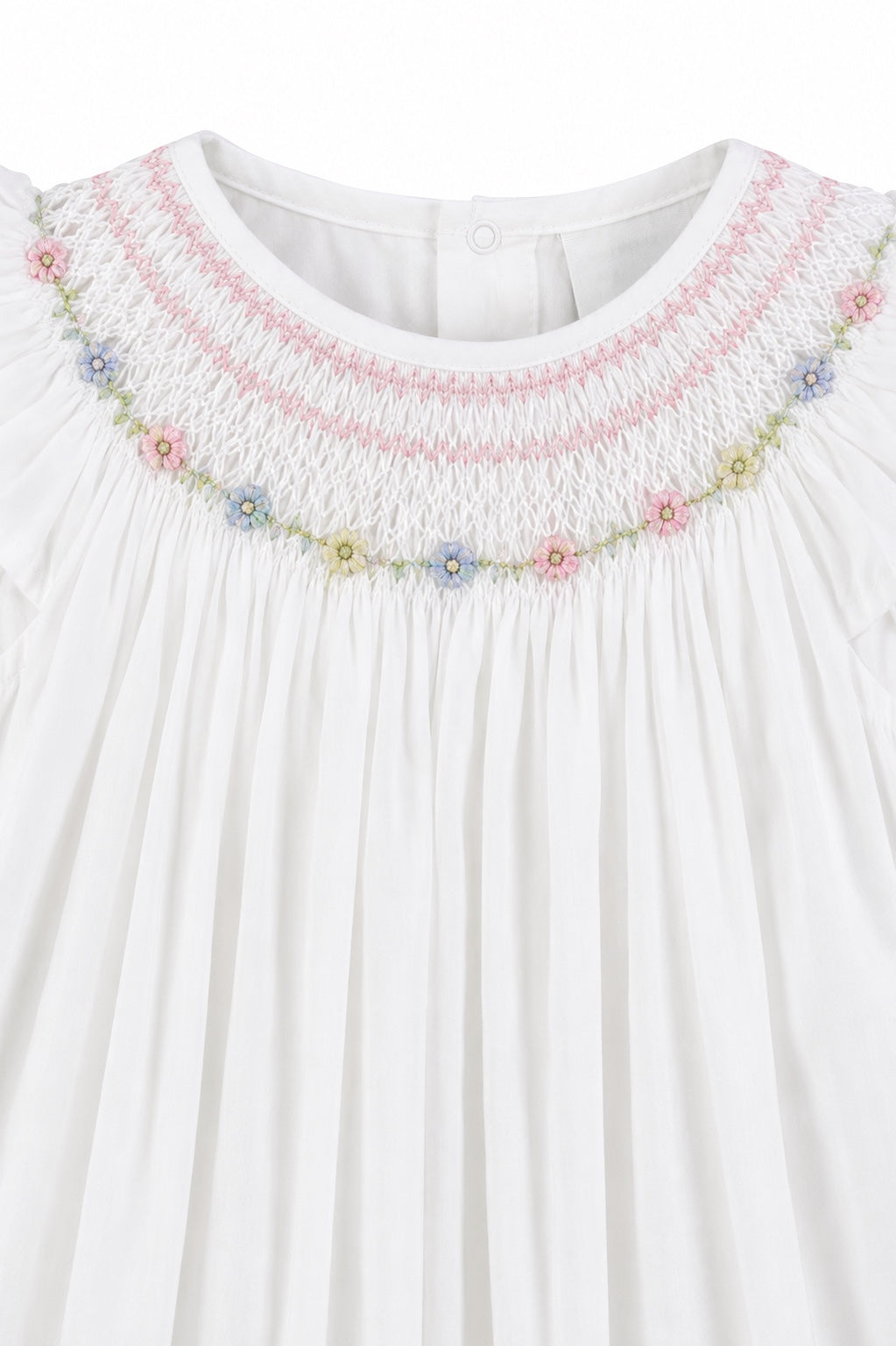 Carriage Boutique white baby girl bishop dress with hand-smocked floral embroidery and delicate flutter sleeves.