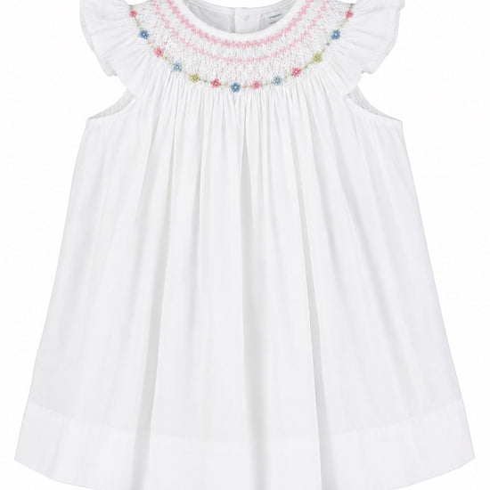 Carriage Boutique white baby girl bishop dress with hand-smocked floral embroidery and flutter sleeves.