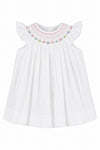 Carriage Boutique white baby girl bishop dress with hand-smocked floral embroidery and flutter sleeves.