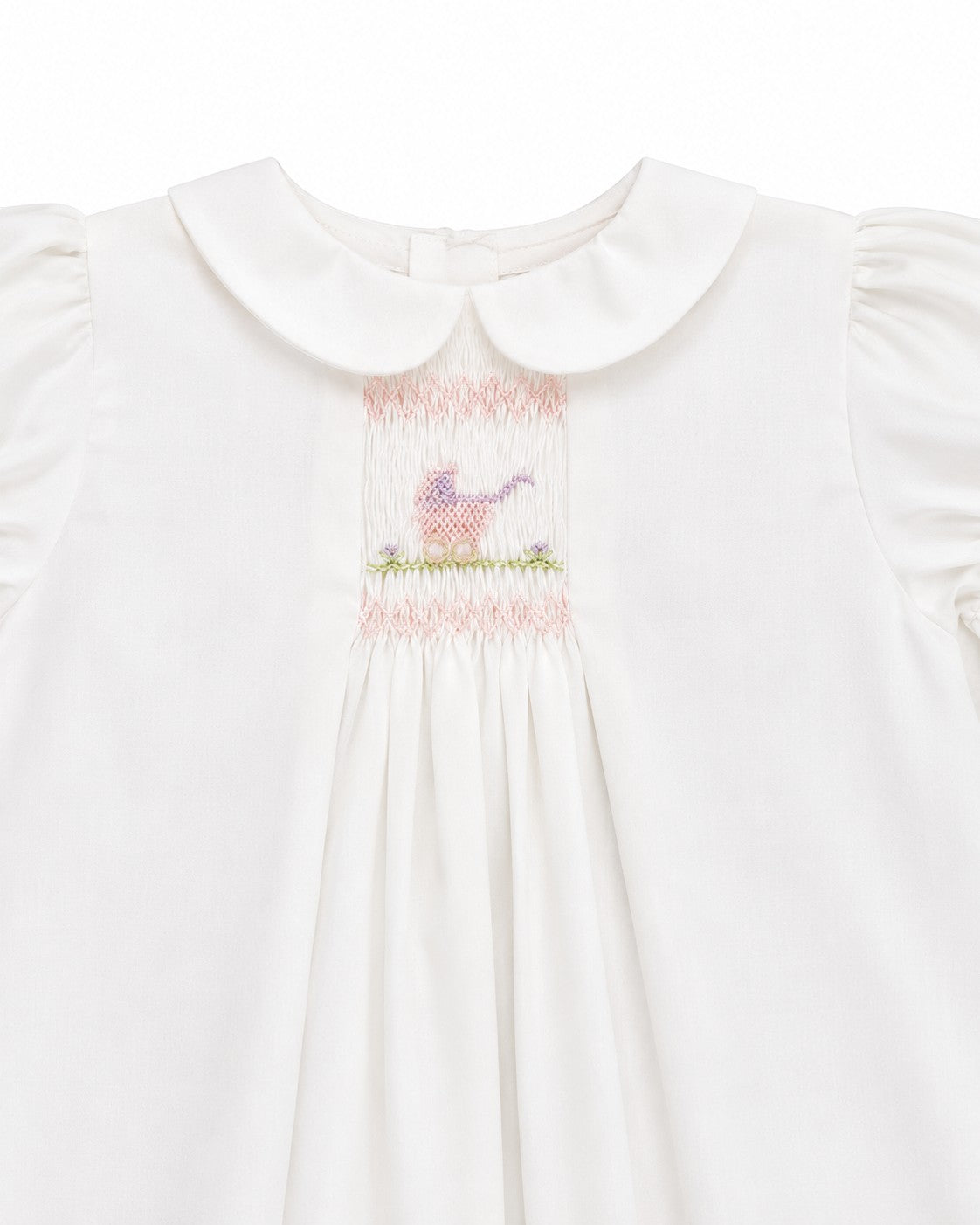 Carriage Boutique white heirloom dress with hand-smocked bodice, Peter Pan collar, and pastel pram embroidery.