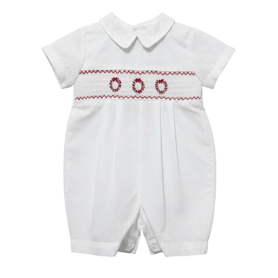 Carriage Boutique white batiste boys shortall with hand-smocked red holiday wreath embroidery and Peter Pan collar.