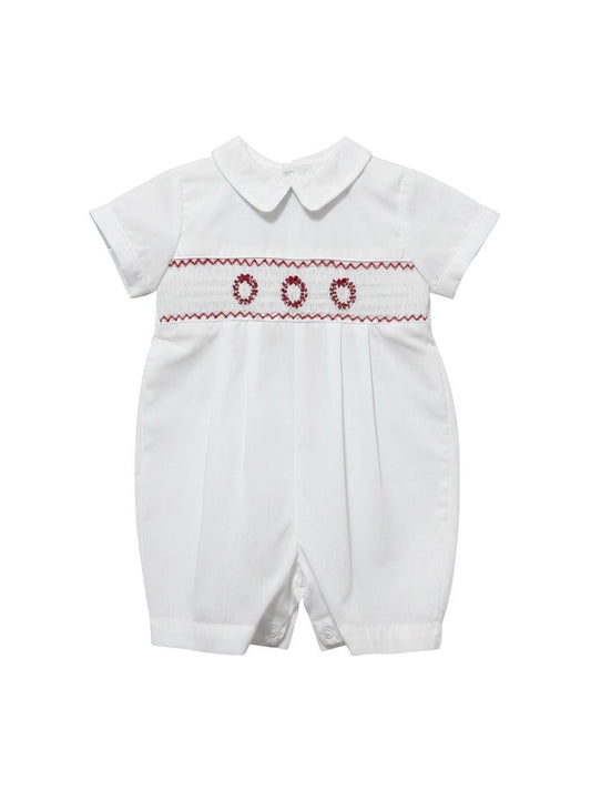 Carriage Boutique white batiste boys shortall with hand-smocked red holiday wreath embroidery and Peter Pan collar.