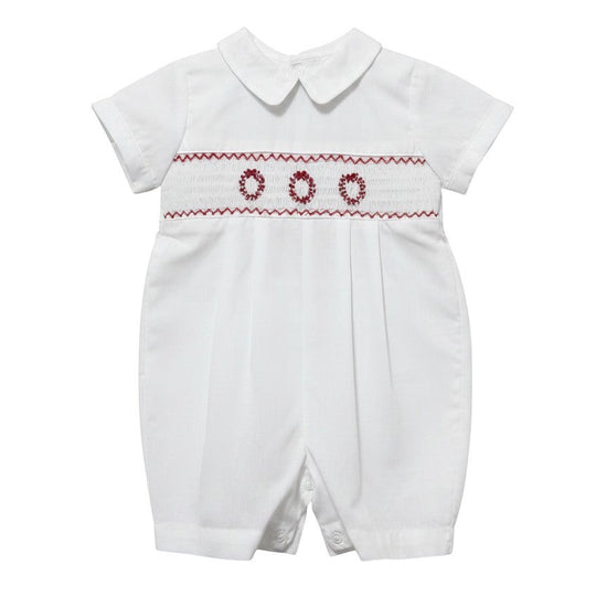 Carriage Boutique white batiste boys shortall with hand-smocked red holiday wreath embroidery and Peter Pan collar.