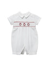 Carriage Boutique white batiste boys shortall with hand-smocked red holiday wreath embroidery and Peter Pan collar.