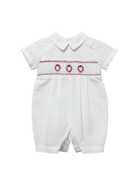 Carriage Boutique white batiste boys shortall with hand-smocked red holiday wreath embroidery and Peter Pan collar.