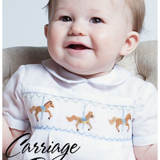 Carriage Boutique white bubble romper with smocked chest featuring carousel horse embroidery and blue piping.
