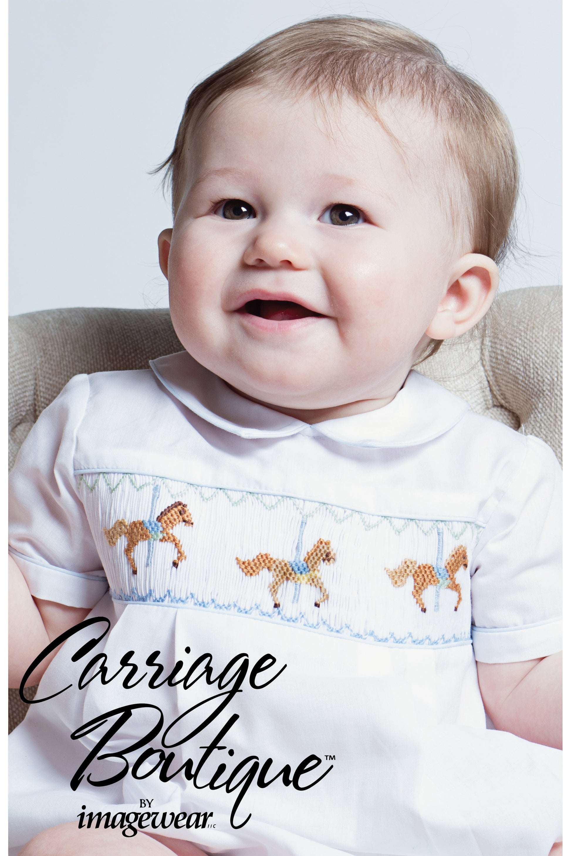 Carriage Boutique white bubble romper with smocked chest featuring carousel horse embroidery and blue piping.