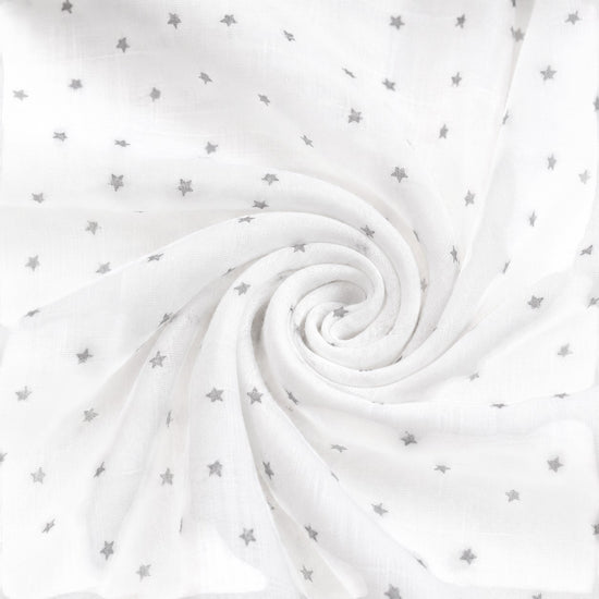 Carriage Boutique white infant sleep gown fabric with a subtle grey star print in a soft, swirled texture.