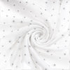 Carriage Boutique white infant sleep gown fabric with a subtle grey star print in a soft, swirled texture.