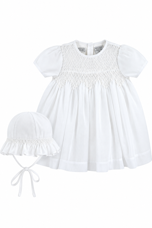 Carriage Boutique white voile christening dress with smocked bodice and matching bonnet for baby girls