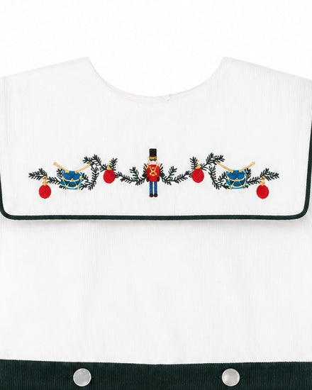 Carriage Boutique white cotton bobbie suit featuring a smocked bib with embroidered wooden soldier and holiday decor